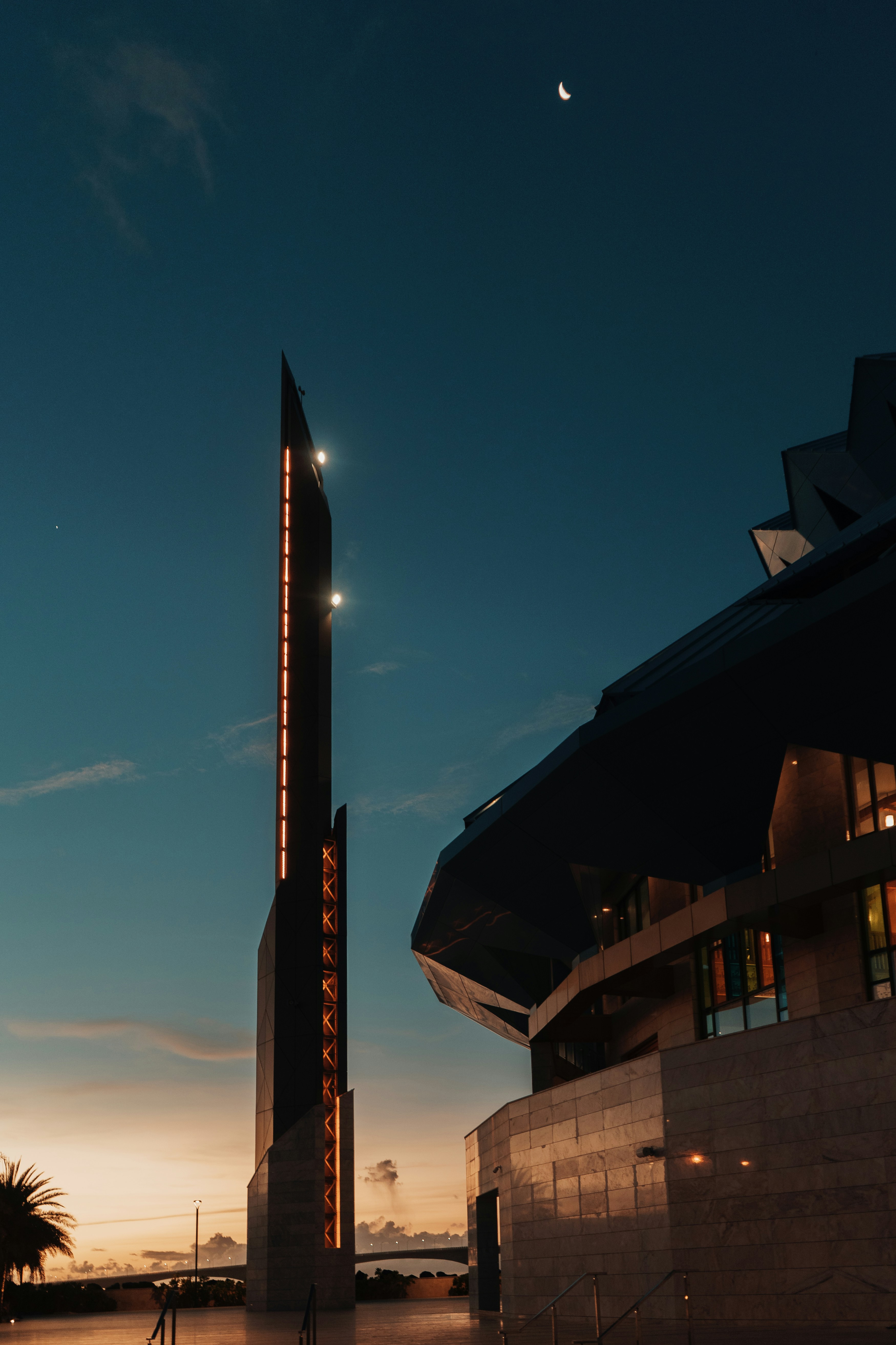 a tall tower with a building in the background