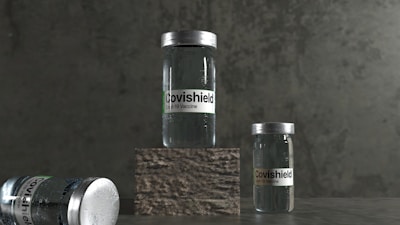 Three vials labeled 'Covishield Covid-19 Vaccine' are positioned against a dark, textured background. Two vials stand upright, with one on a raised stone-like platform, while another lies on its side.