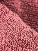 Softly lit close-up of the blush pink fabric texture highlighting delicate stitching.