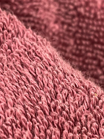 A close-up shot of a soft cotton shirt in a vibrant color, highlighting the fabric texture.