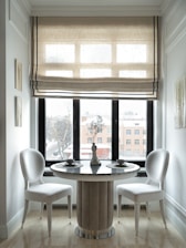 A cozy dining nook featuring smarthauls' elegant tableware and decor with warm natural light streaming in.