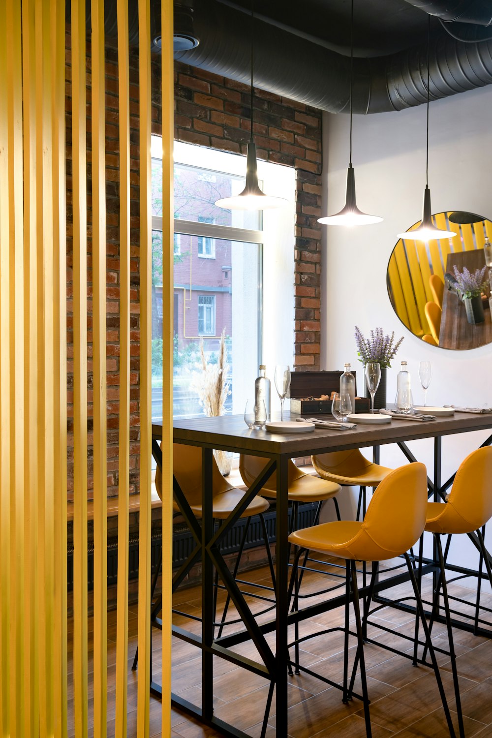 a dining table with yellow chairs