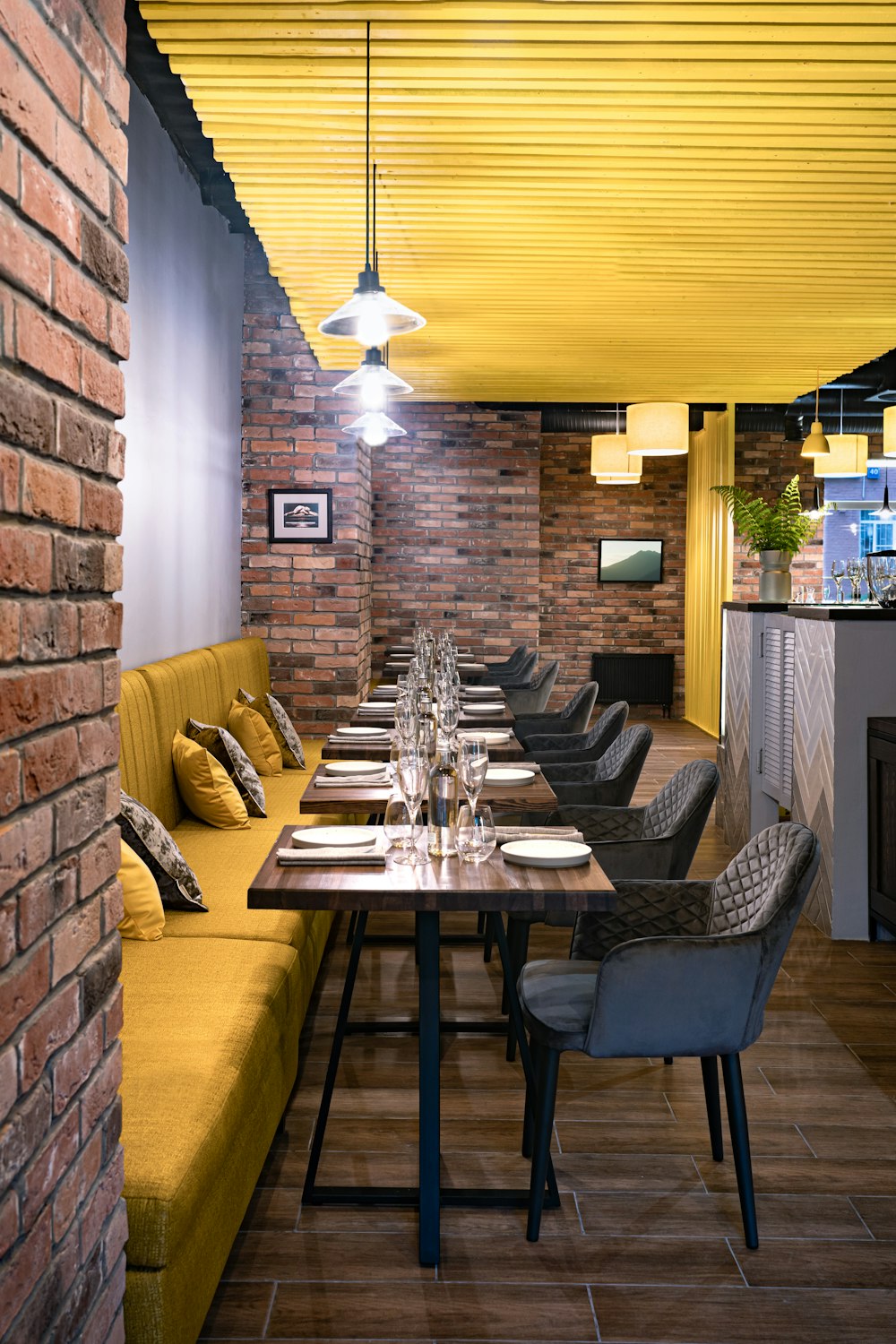 a dining room with a brick wall