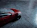 Close-up of a bright, detailed toy car from grynlax feton llc on a wooden floor.
