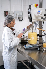 a man in a white coat working in a lab