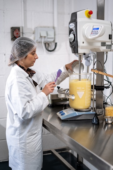 a man in a white coat working in a lab
