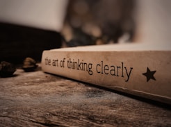 a white box with black text on a wooden surface