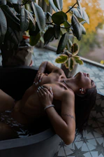 a couple of women lying on a couch