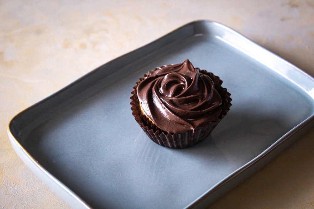 a chocolate cupcake on a plate