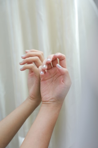 a pair of hands holding a white cloth