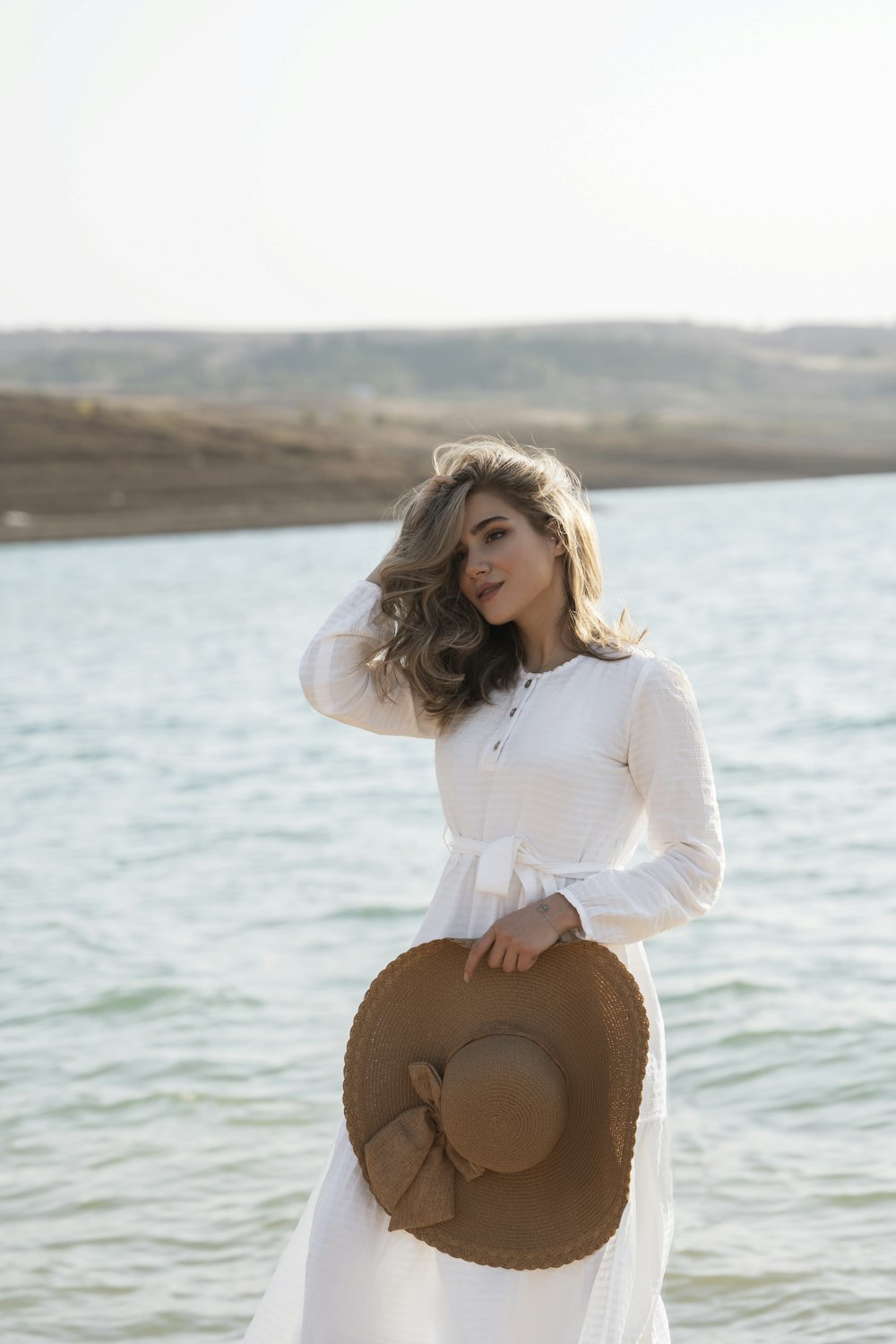 a person standing next to a body of water