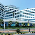 a building with a walkway and trees