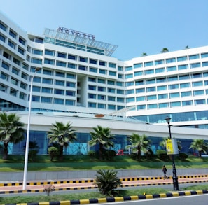 a building with a walkway and trees