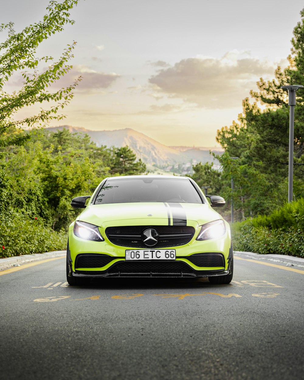 a green car on a road