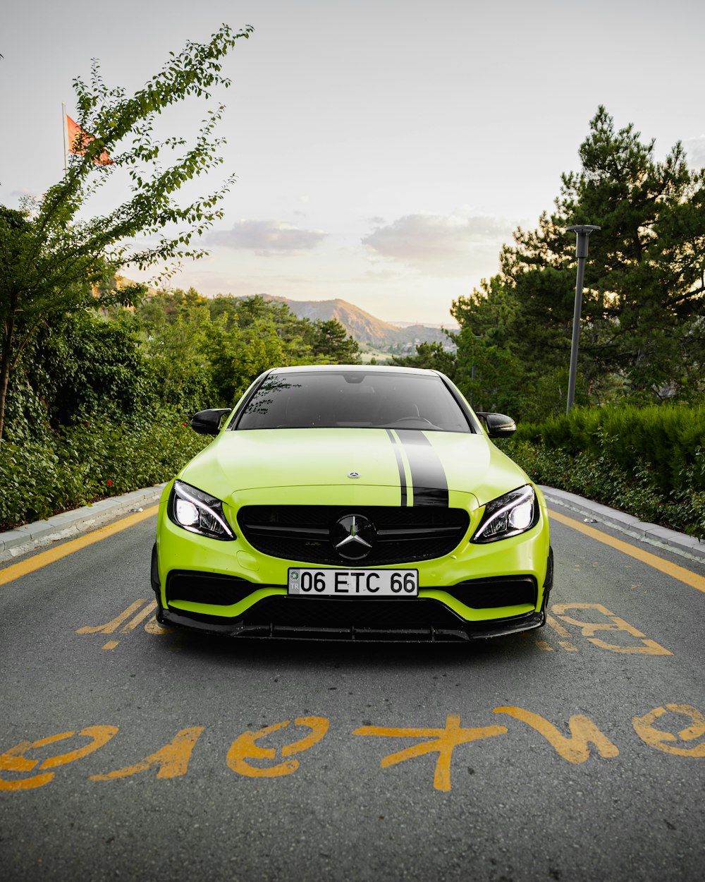 a green car on a road