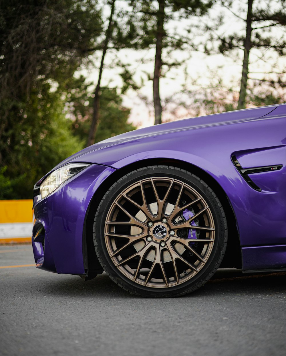 a purple car with a black rim
