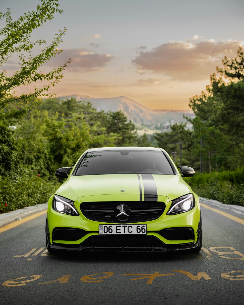 a green car on a road