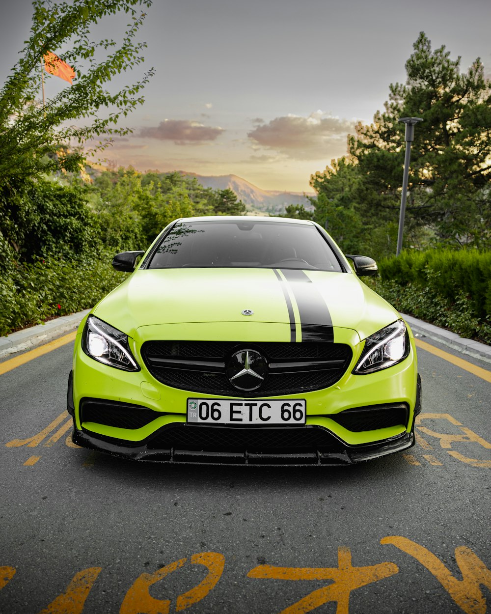 a green car on a road