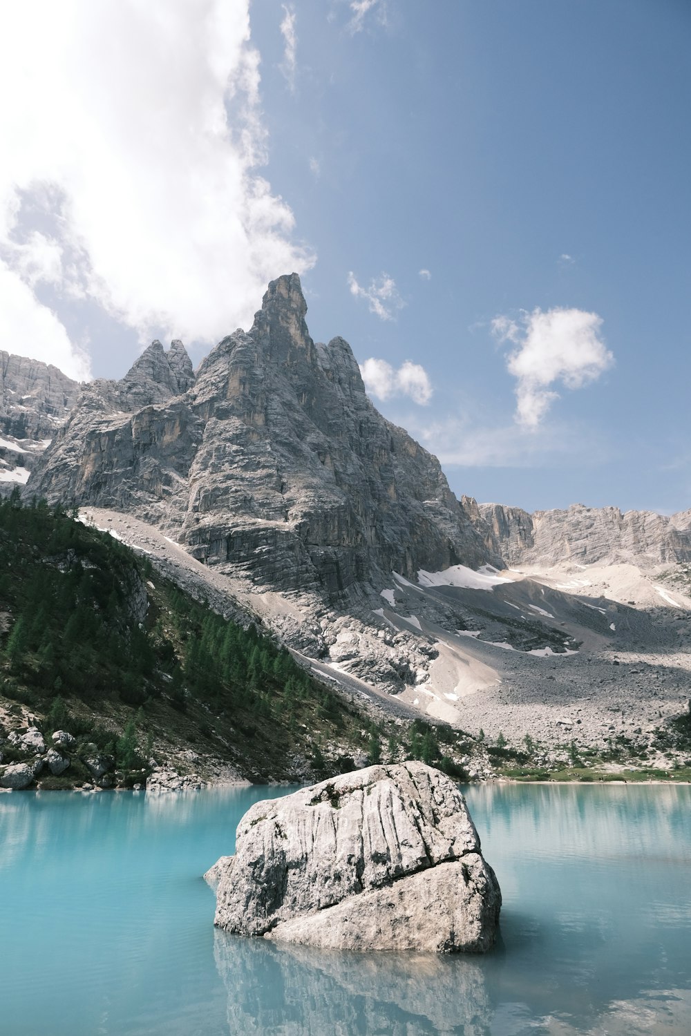 a large mountain with a body of water below