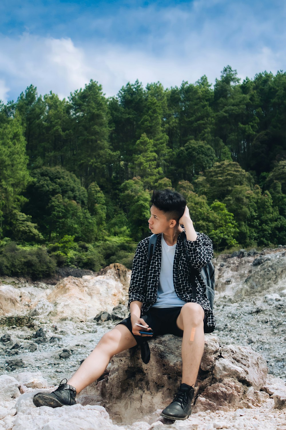 a man sitting on a rock