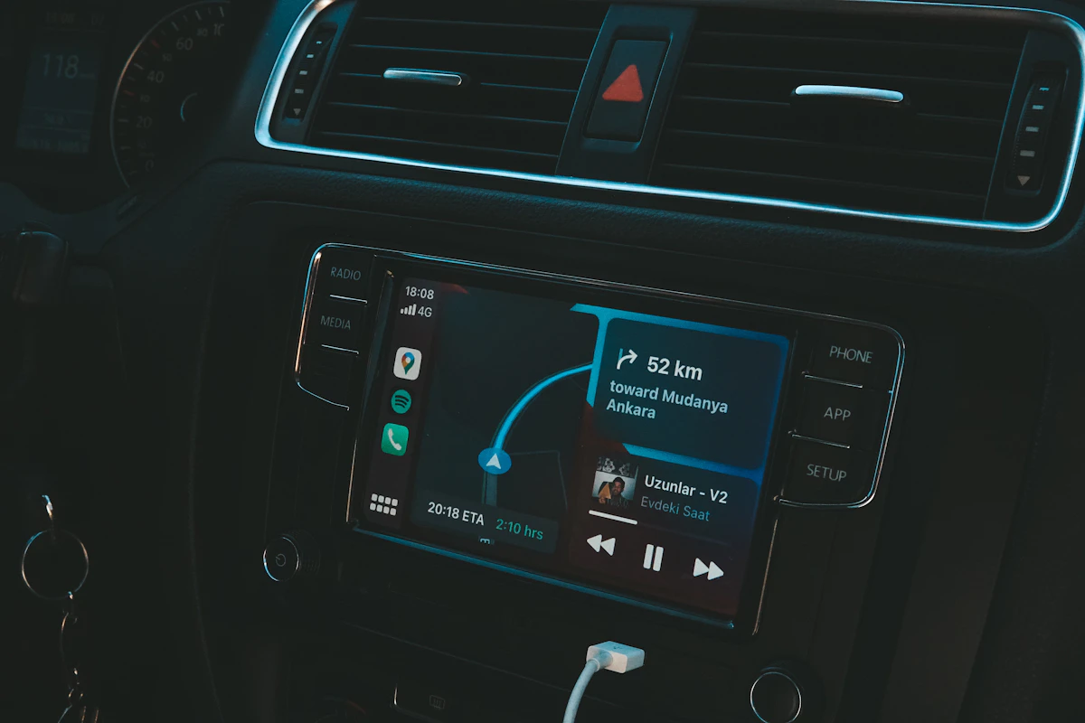 Android Auto navigation screen with turn-by-turn directions and music controls