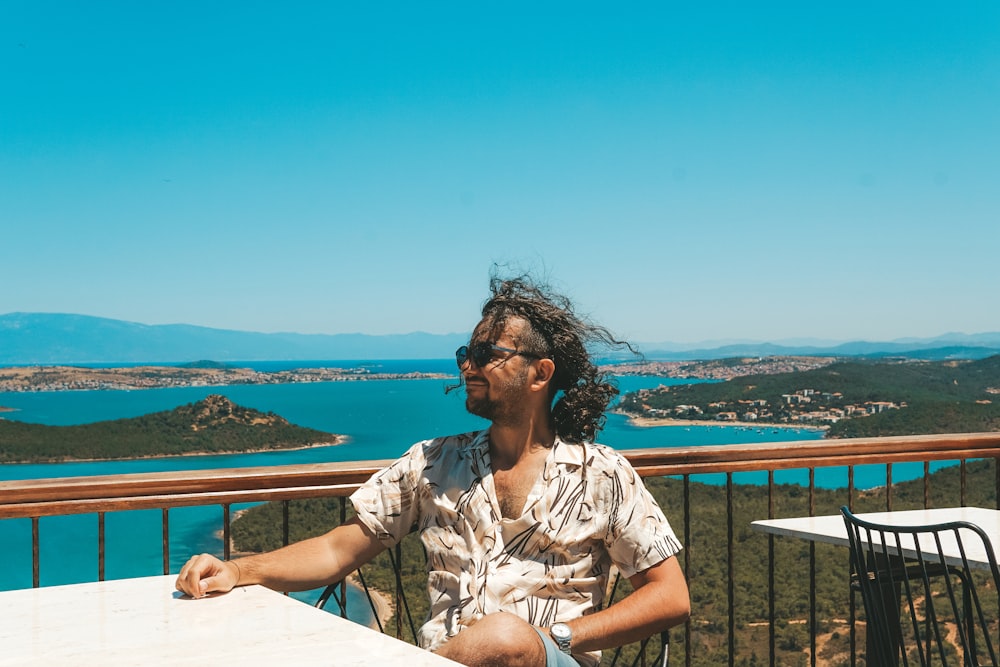 a person sitting on a balcony overlooking a city