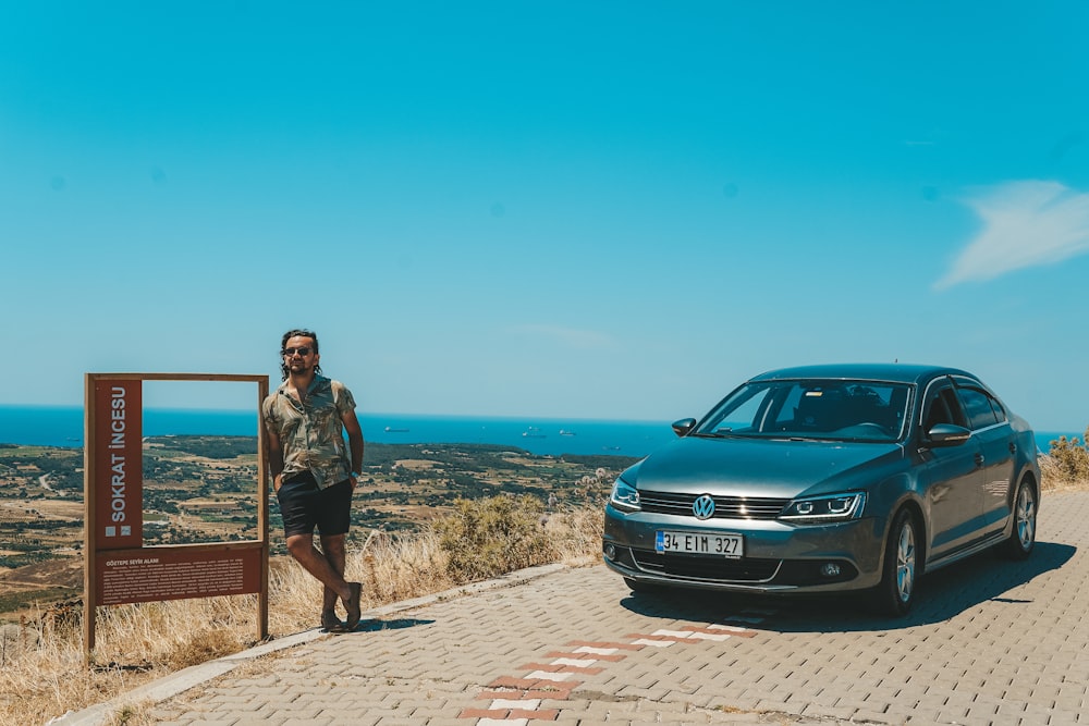 a person standing next to a car