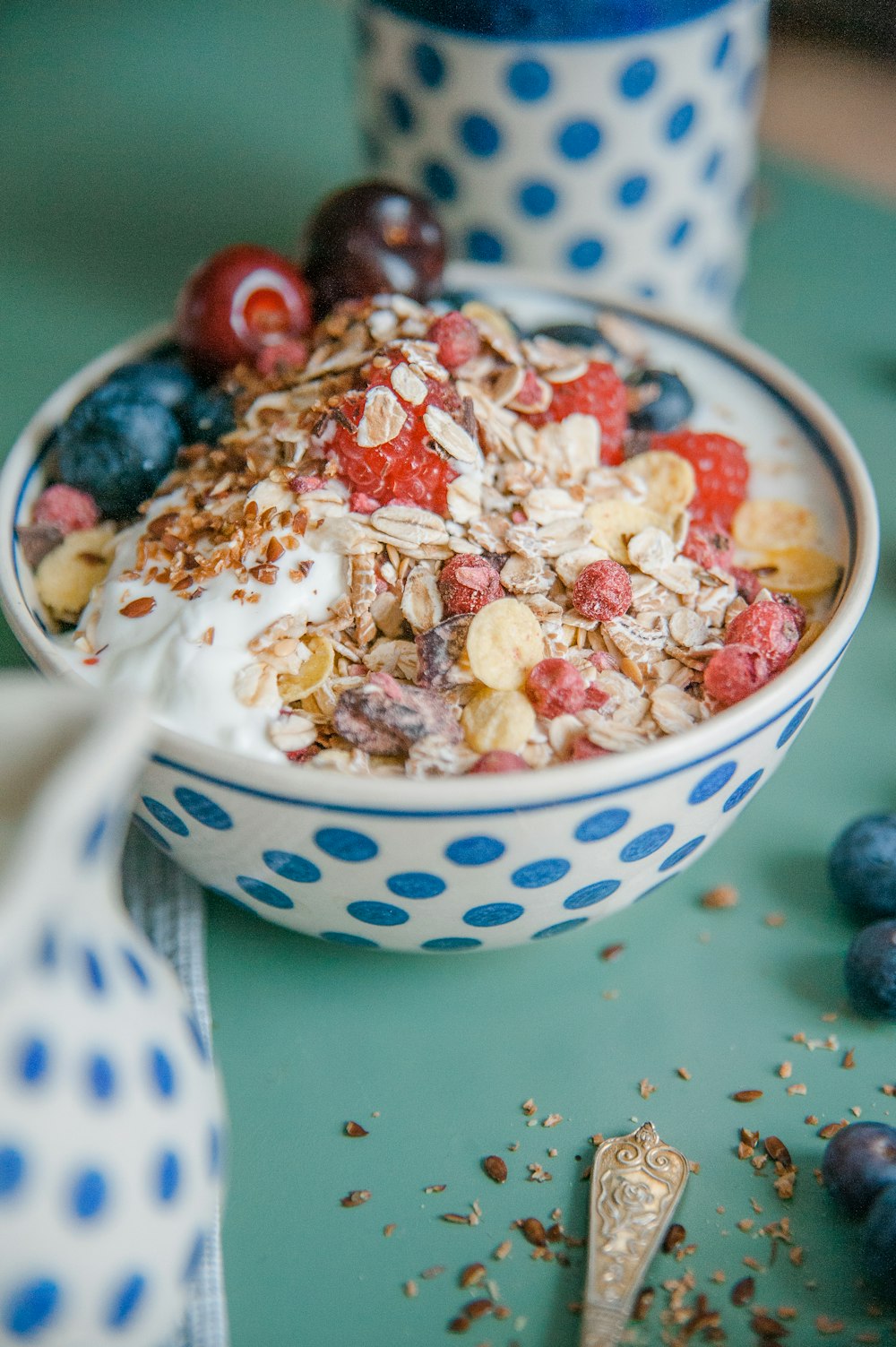 a bowl of cereal with milk and berries