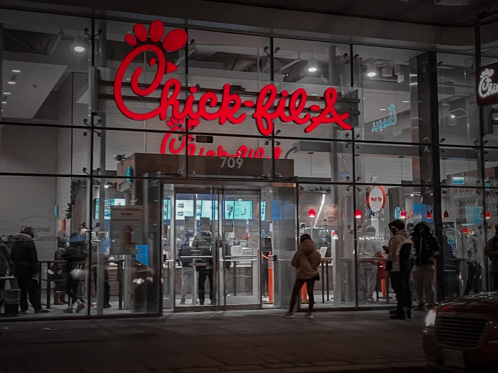 a store front with people walking by