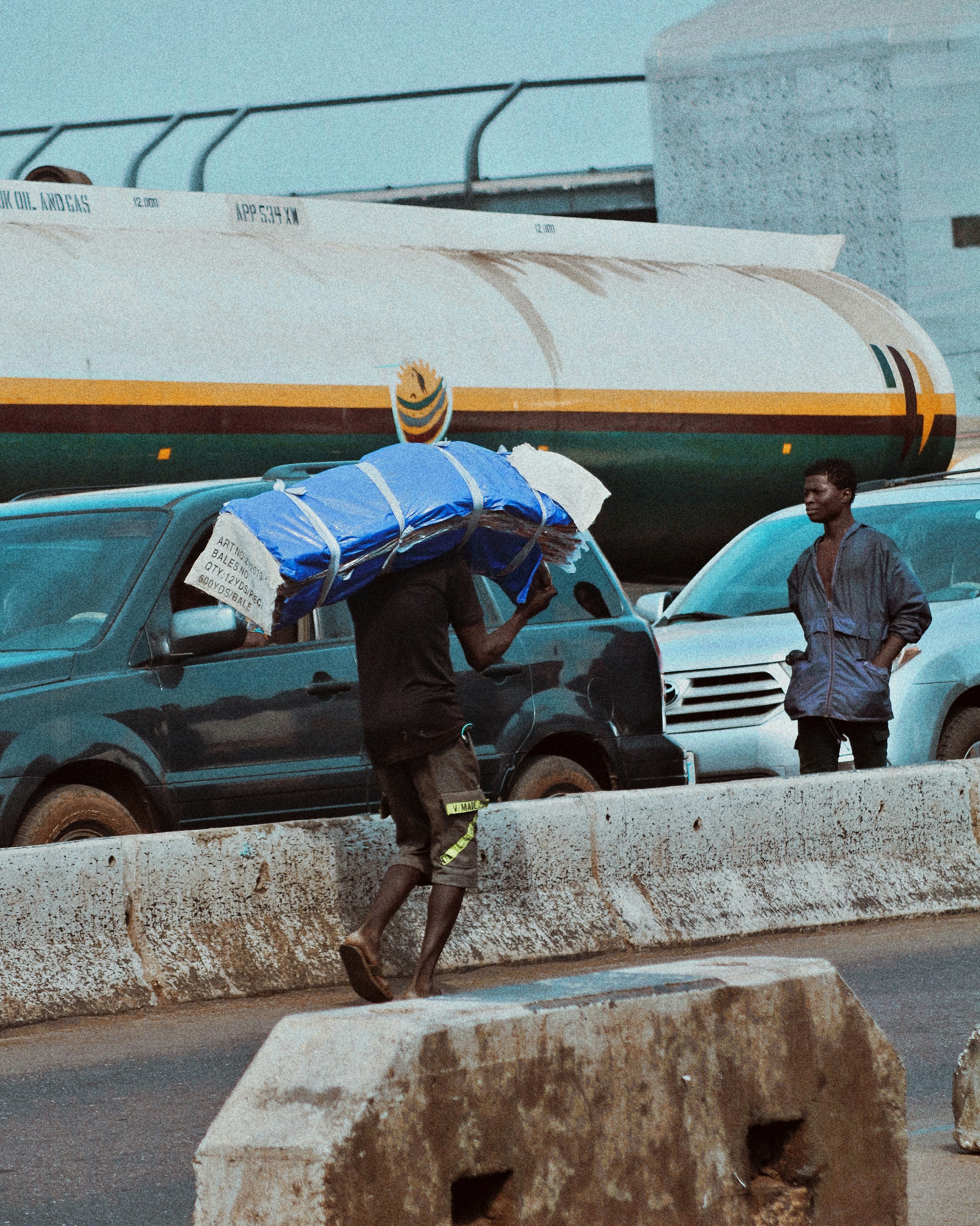 Alabaru (A Porter) rolling a wheel barrow in Lagos Market as a means of survival.
