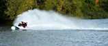 An action shot capturing a jet ski rider making a sharp turn, splashing water around.