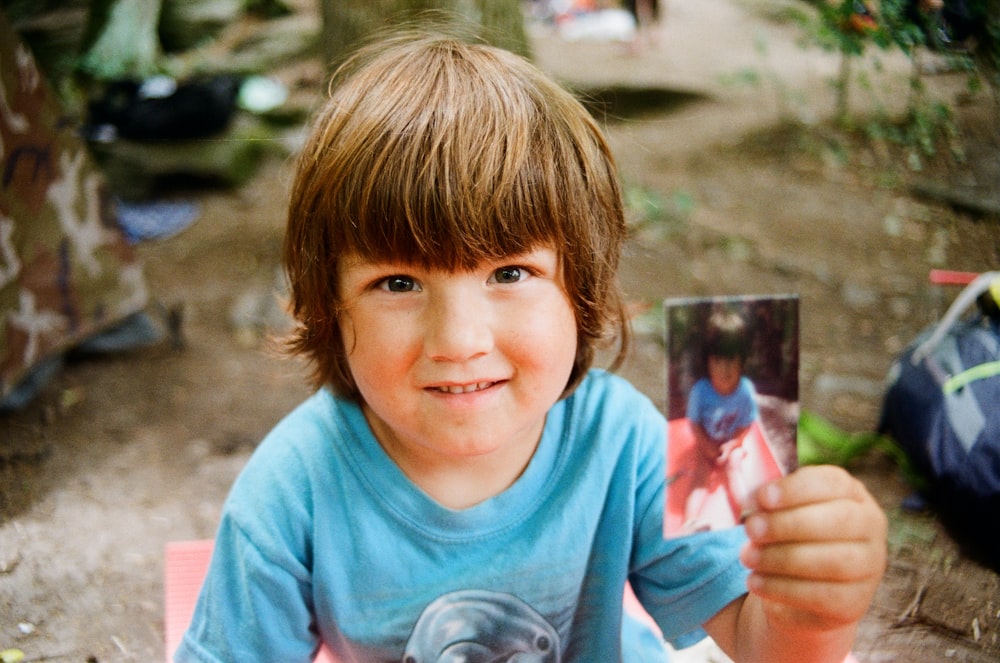 a child holding a card