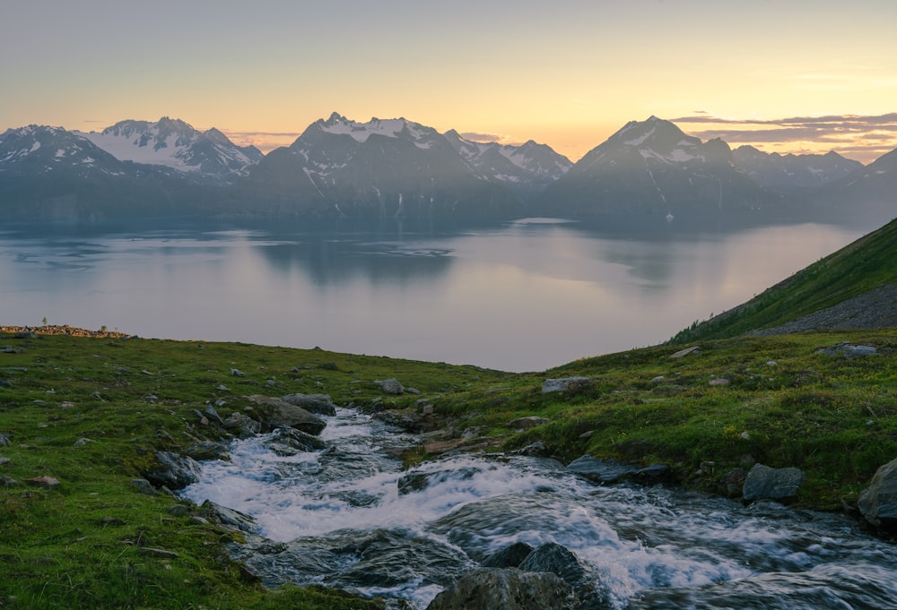 a body of water with mountains in the background