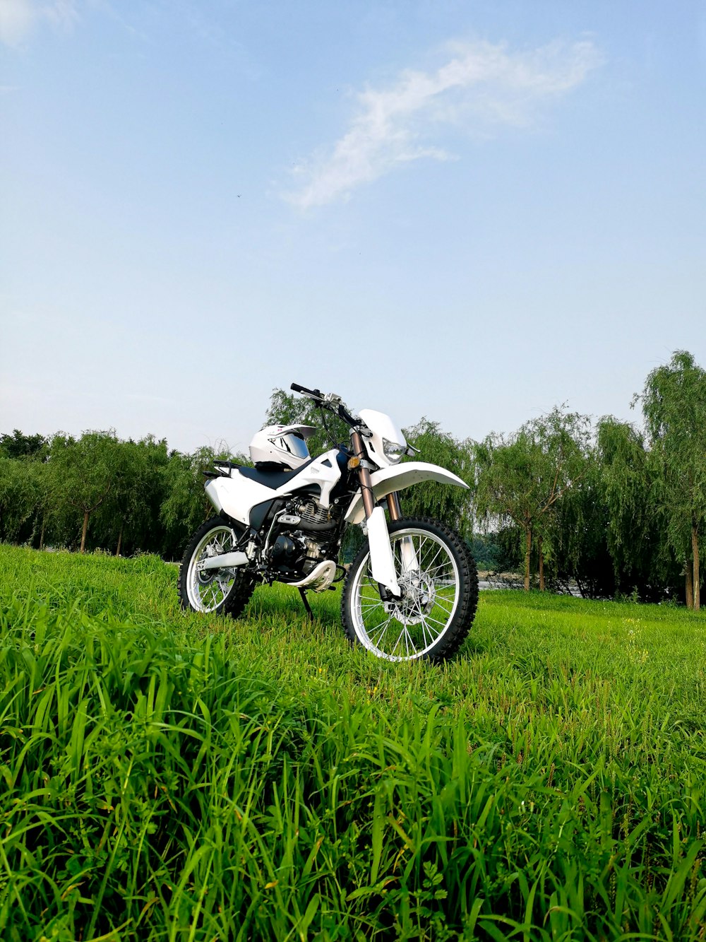 a motorcycle parked in a grassy field