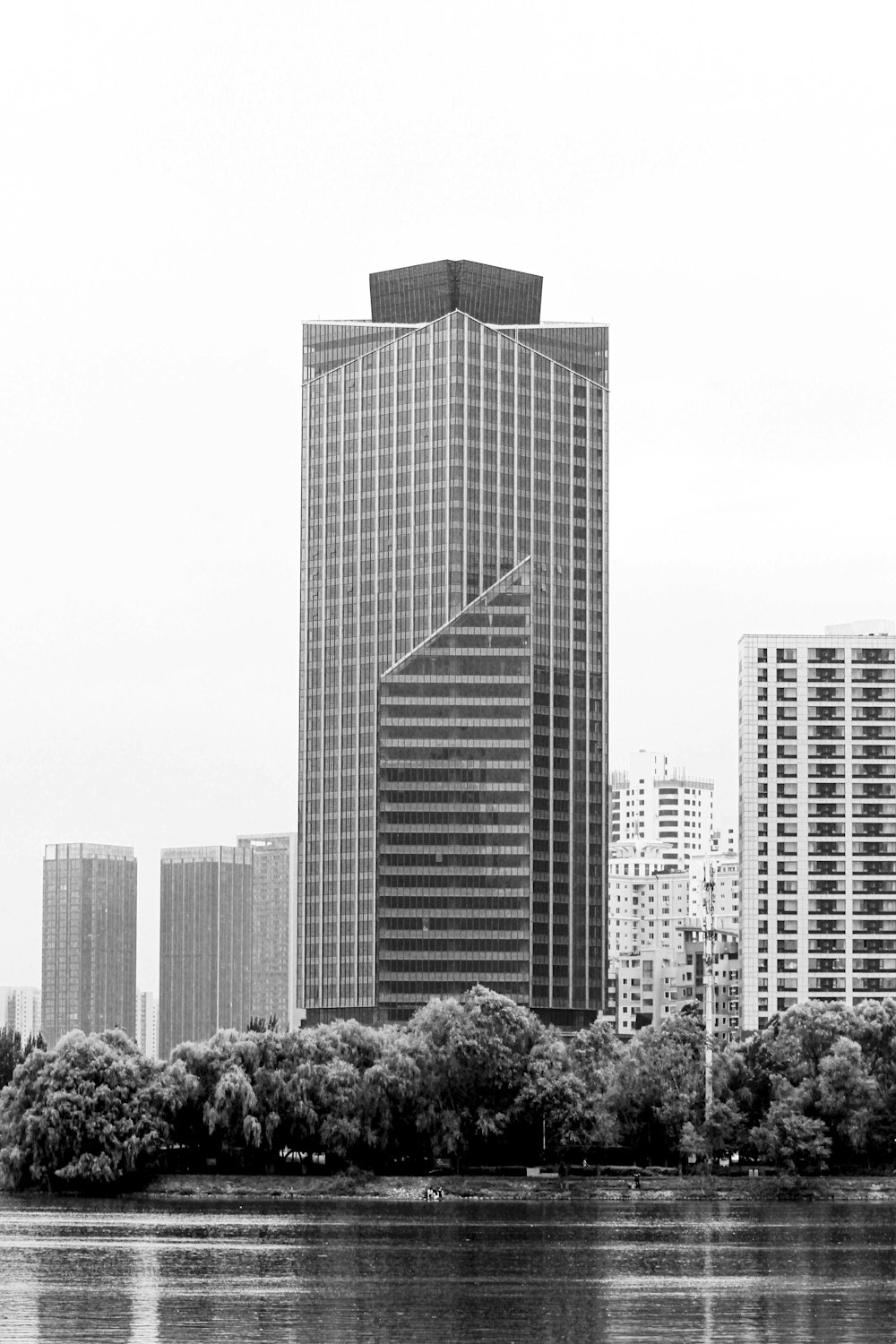 a group of tall buildings by a body of water