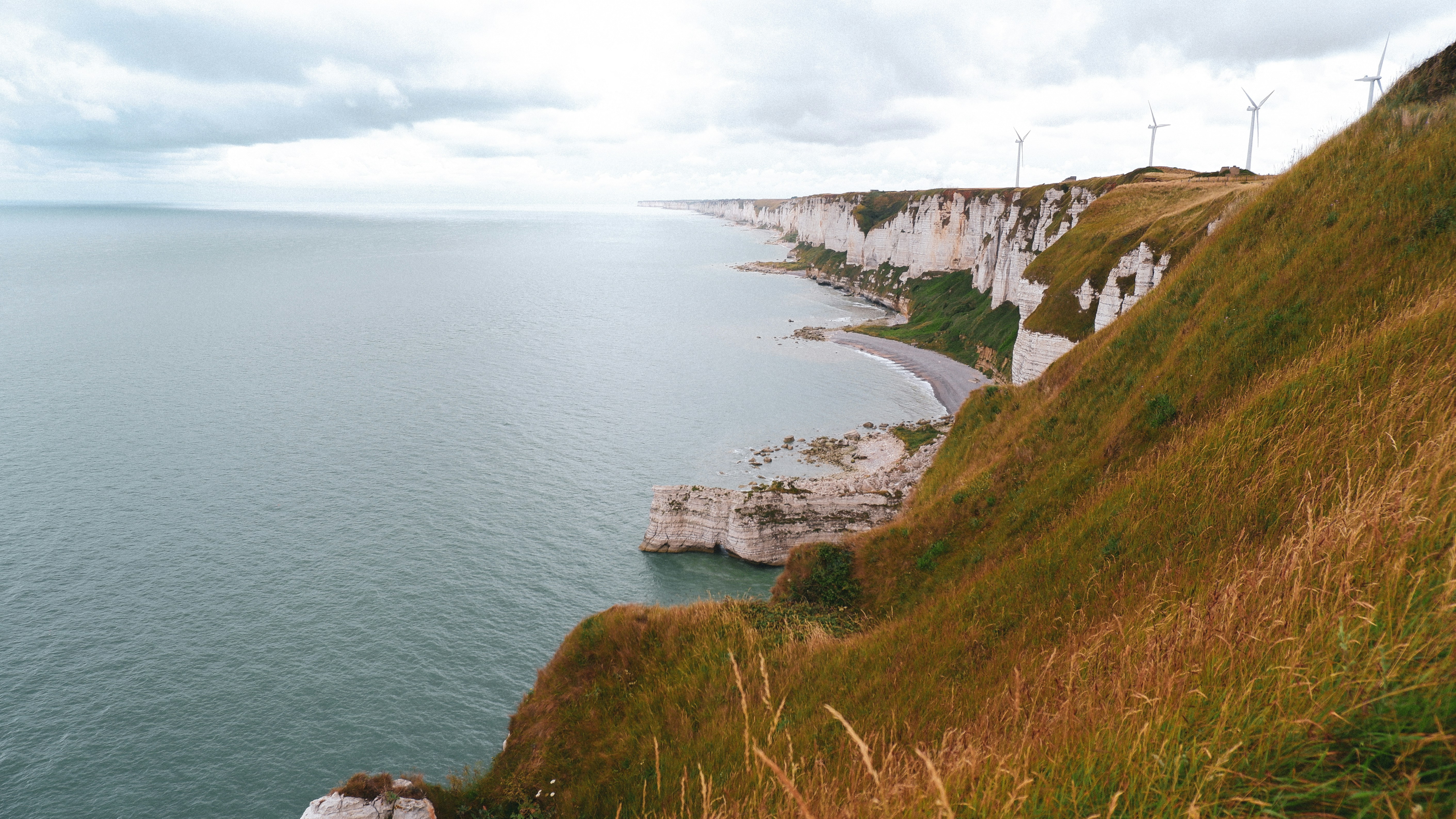 a cliff side with a body of water below