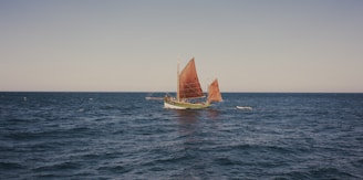 A classic 15-meter sailboat navigating the Caribbean waters.