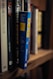 A close-up view of a shelf lined with several books. One book has a bright blue spine with the title 'Ten Year Career' by Jodie Cook written in yellow block letters. Surrounding it are various other books with titles visible, including 'Gray Vaughan' and 'Maier'. The books are neatly arranged, creating a sense of order.