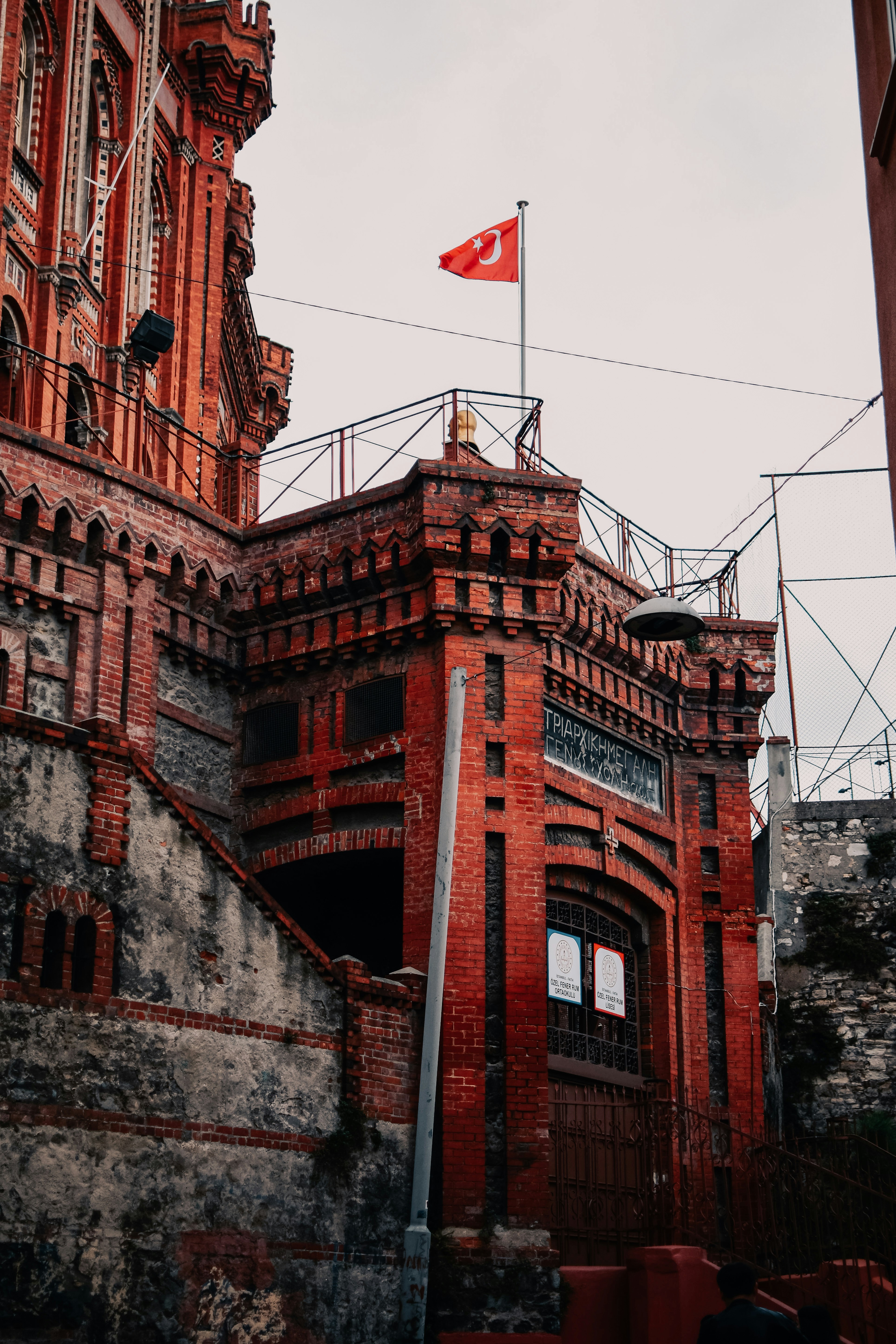 a brick building with a flag on top