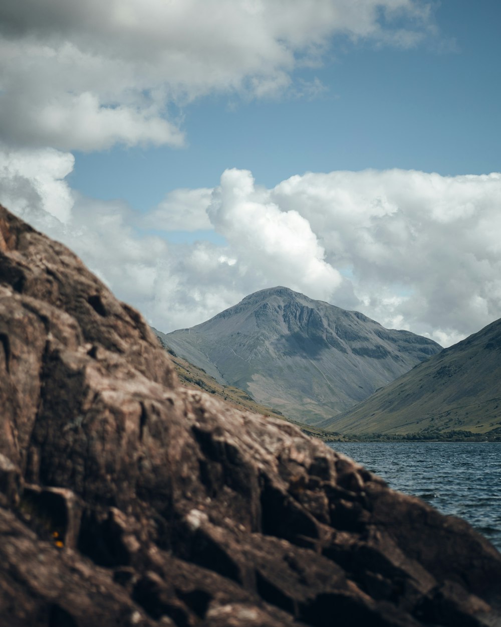 a body of water with mountains around it