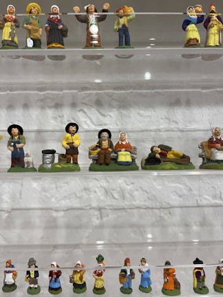 High-end collectible ceramic figurines arranged artistically on a shelf.