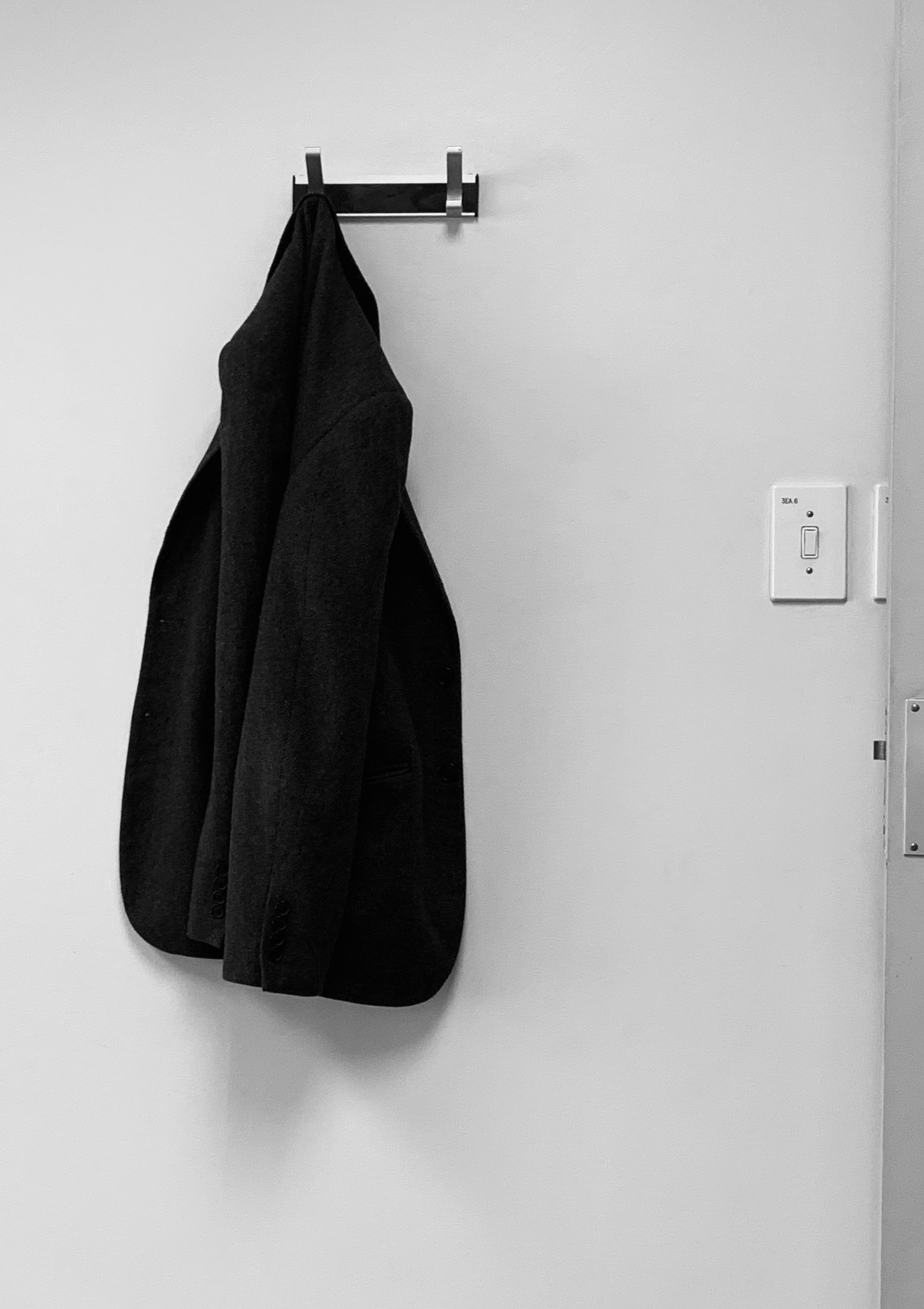 a black jacket on a white wall