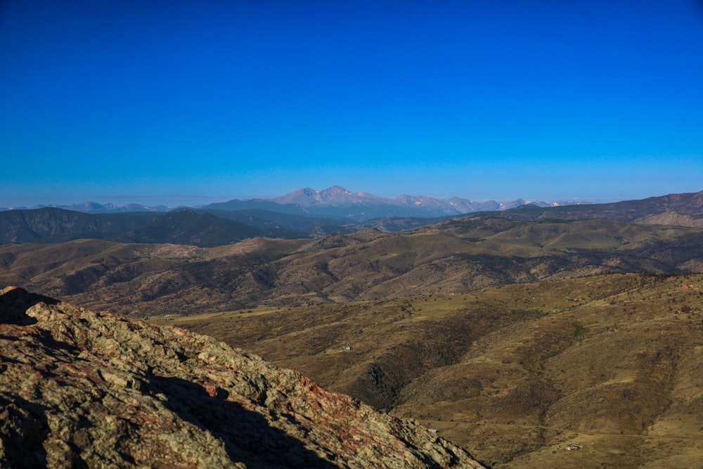 a landscape with hills and mountains in the background