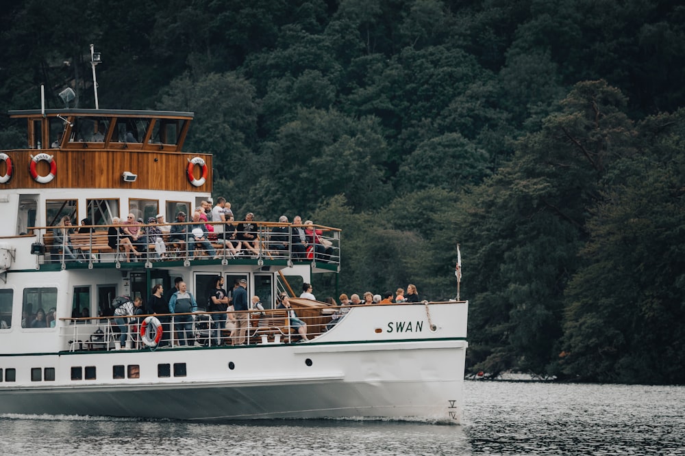 a boat full of people sailing on the water