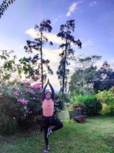 Person practicing breathwork in a serene natural setting at sunrise.
