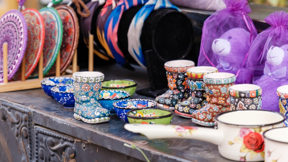 a table full of colorful vases