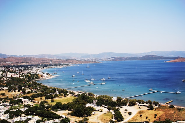 A scenic view of Pittwater's coastline with boats anchored in the bay.