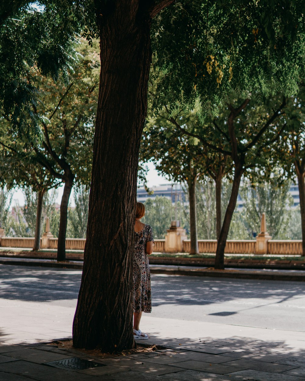 a person standing next to a tree