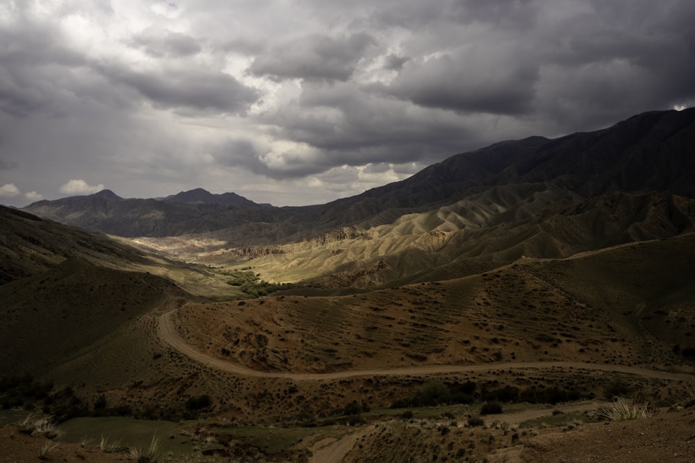 a landscape with hills and clouds