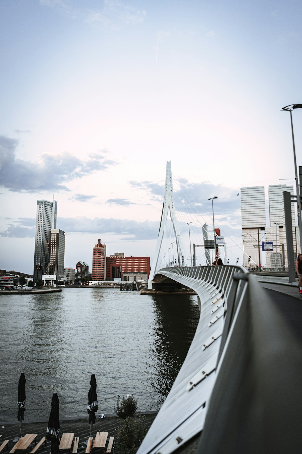 a bridge over a body of water with buildings in the background